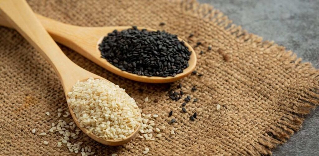 Black and white sesame seeds in bowls for metabolic health audit.